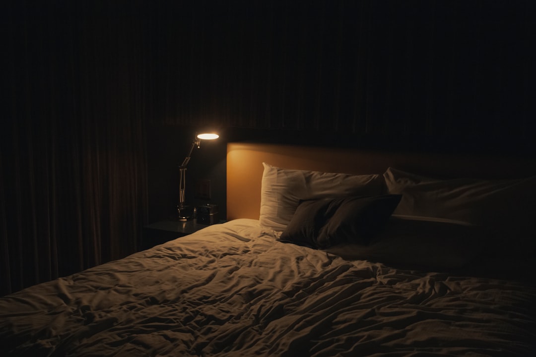 A serene and cozy bedroom setup with soft lighting, comfortable bedding, and calming decor, promoting a restful atmosphere.